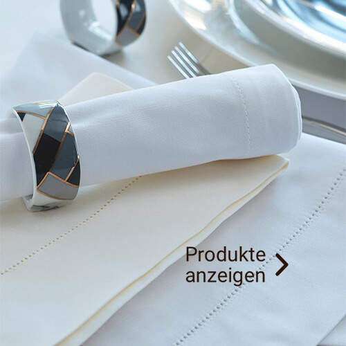 Gedeckter Tisch mit Stoffservietten und Serviettenringen in silber